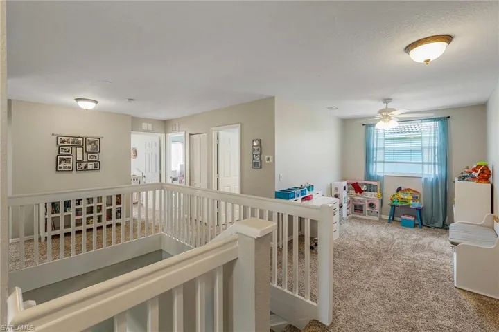 Corridor with a textured ceiling and carpet floors