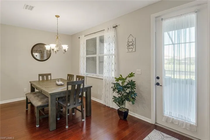 Dining area featuring dark hardwood / wood-style floors and a chandelier