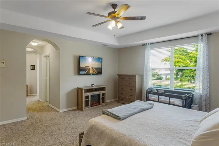 Bedroom with light colored carpet and ceiling fan