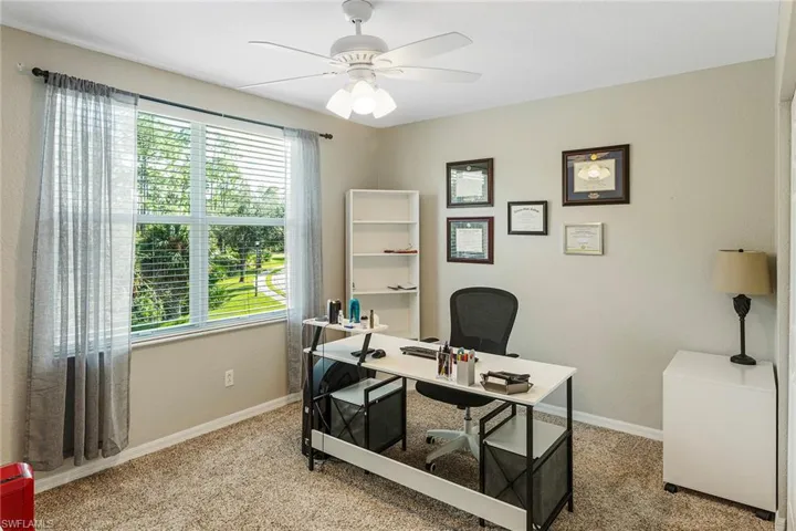 Office featuring light carpet and ceiling fan