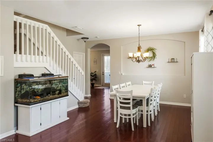 Dining space featuring a chandelier and dark hardwood / wood-style flooring