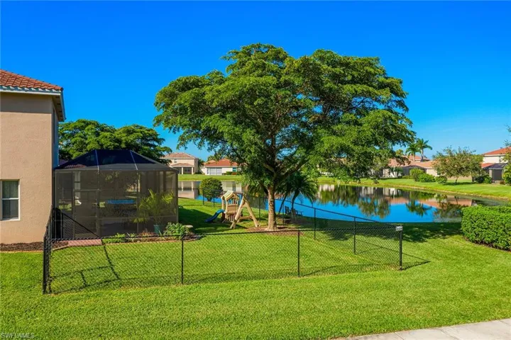 Surrounding community featuring a water view and a yard