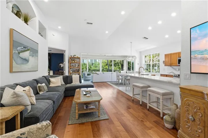 Large, open great room room opens to the glass enclosed lanai overlooking the lake.