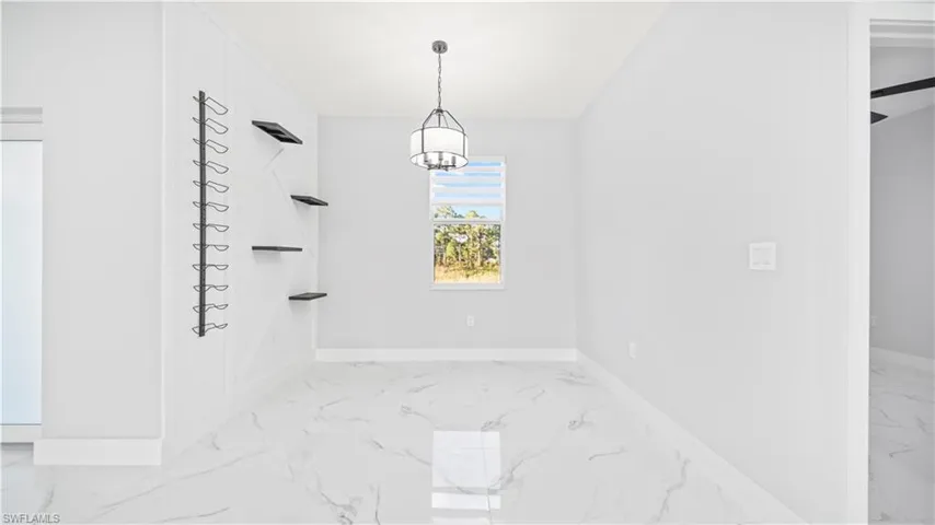 Unfurnished dining area with light marble finish floors