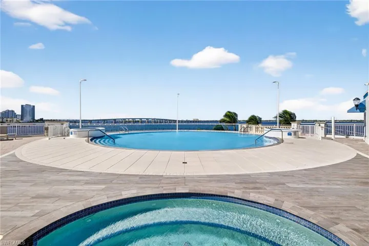 Community pool featuring a hot tub