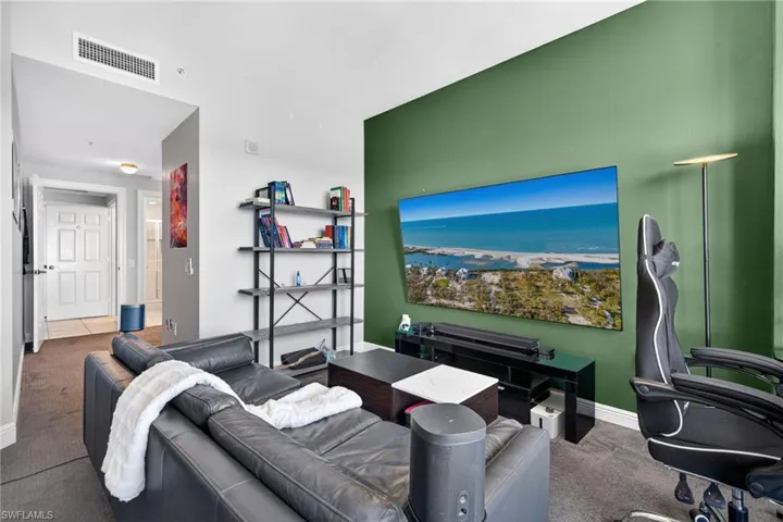 Carpeted living room featuring baseboards