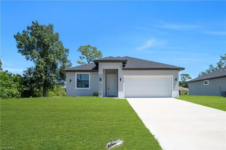 Contemporary single-story residence featuring a light gray exterior with white trim