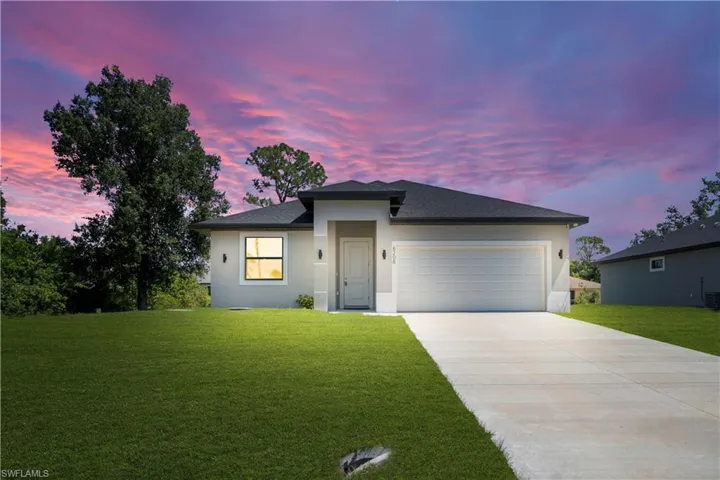 Contemporary single-story residence with a dark shingle roof and light stucco exterior