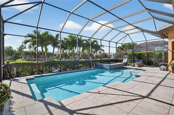 View of pool featuring a sunroom, a lanai, a patio, and a pool with connected hot tub