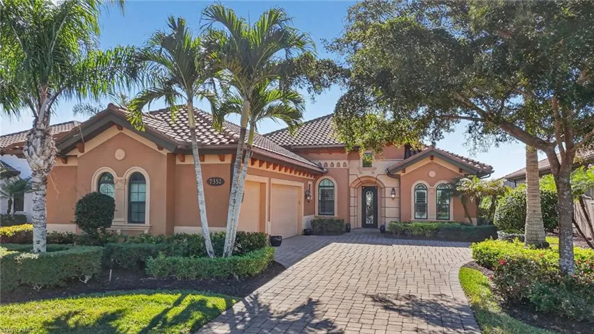 Mediterranean / spanish-style house featuring stucco siding, decorative driveway, a tiled roof, and an attached garage