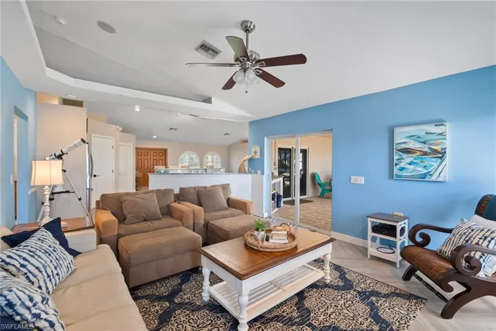 Living room featuring lofted ceiling and ceiling fan