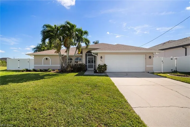 Single story home with a garage and a front yard