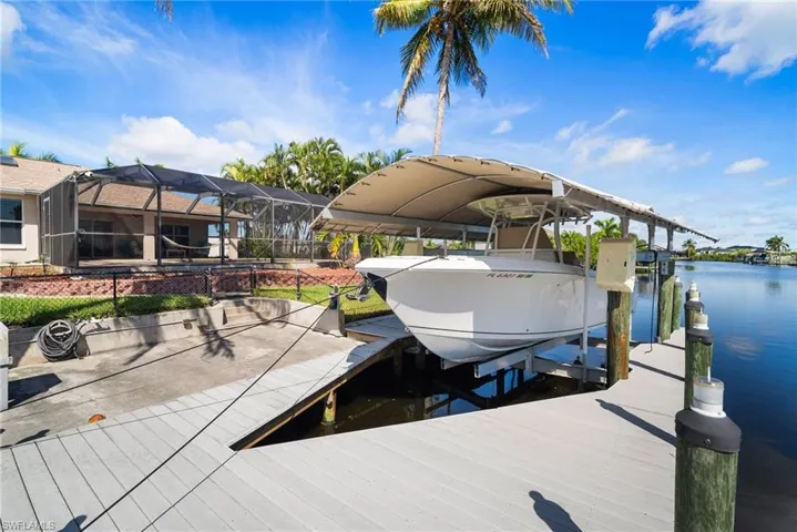 View of dock with a water view and a lanai