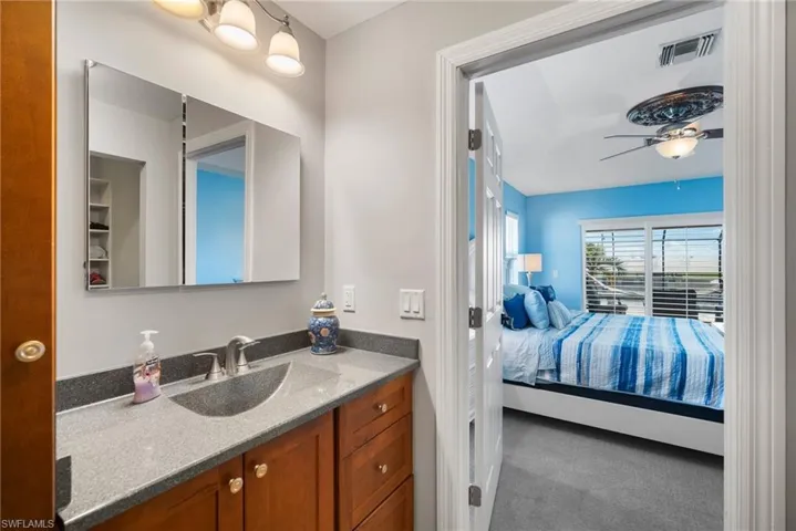 Bathroom with vanity and ceiling fan
