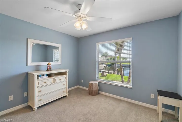 Misc room featuring ceiling fan and light colored carpet