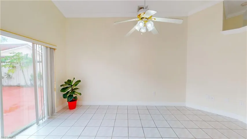 Spare room with ornamental molding and ceiling fan