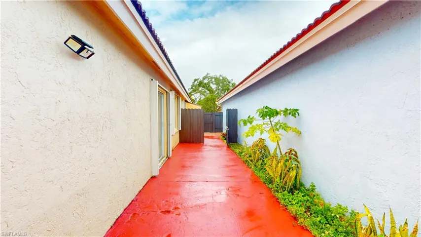 View of side of property with stucco siding and a patio area