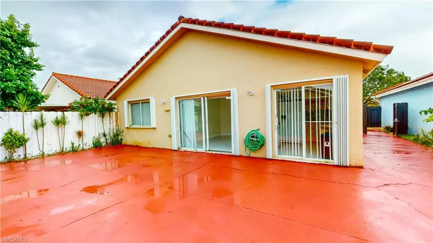 Back of property featuring a patio area, stucco siding, and a tile roof