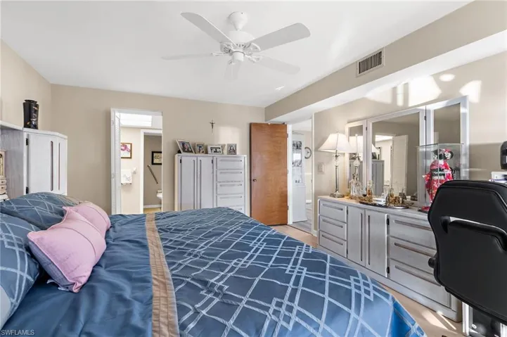 Bedroom featuring ensuite bathroom and a ceiling fan