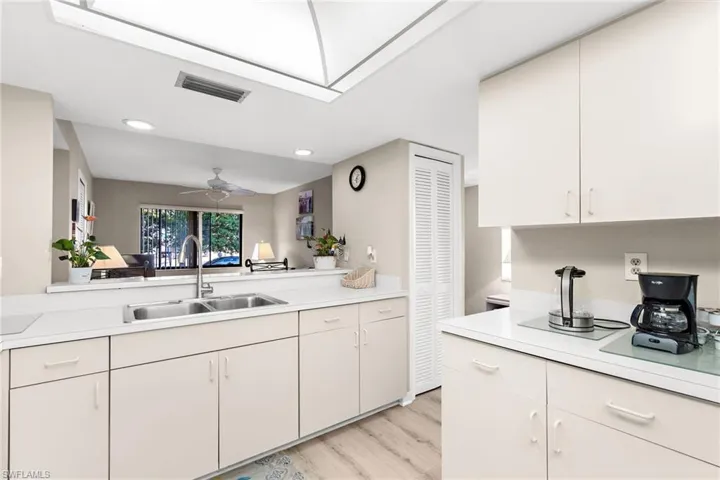 Kitchen featuring light countertops, recessed lighting, a ceiling fan, and light wood-style floors