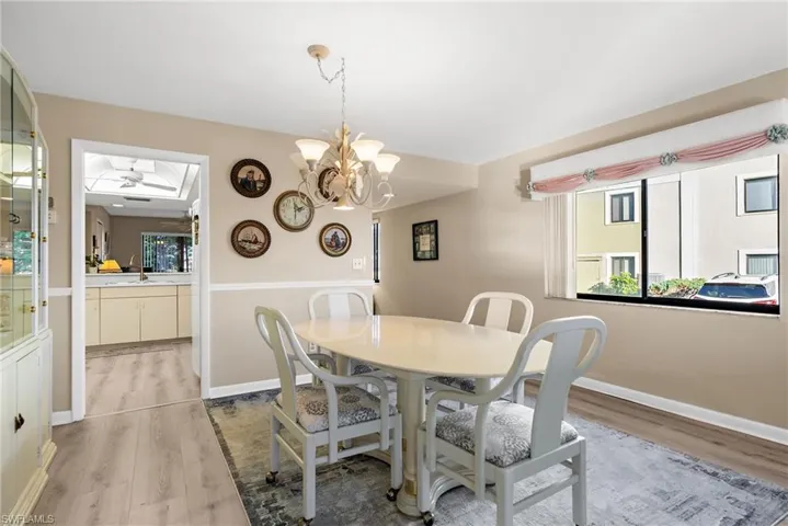 Dining area with light wood-type flooring and a chandelier