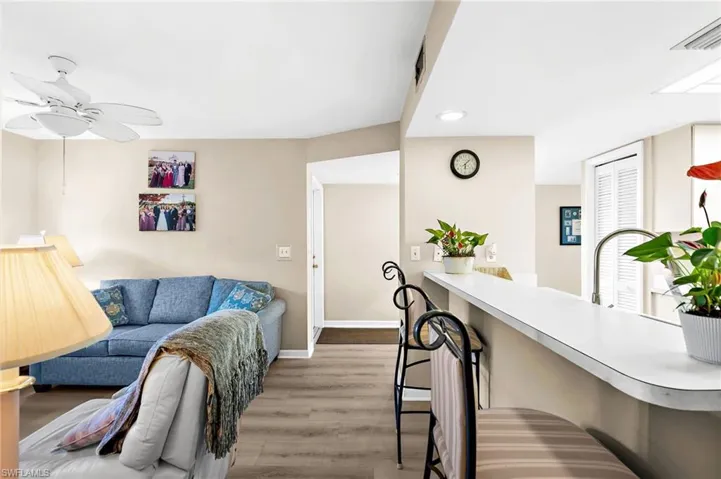 Living room featuring light wood-style floors and a ceiling fan
