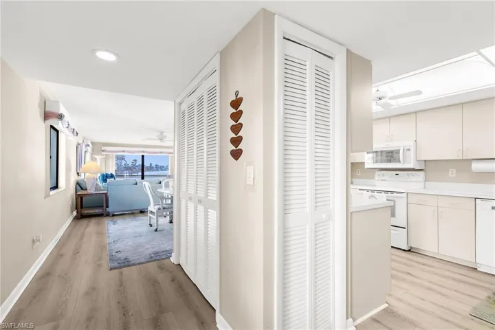 Hall featuring light wood finished floors and recessed lighting