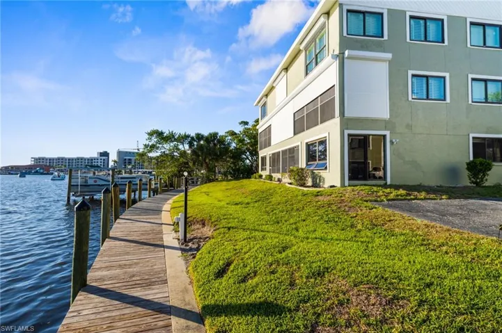 Dock featuring a water view and a lawn