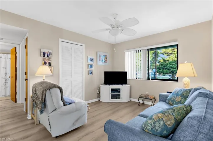 Living room with ceiling fan and wood finished floors