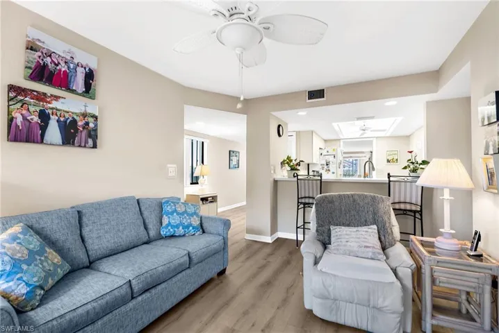 Living room featuring ceiling fan, wood finished floors, and recessed lighting