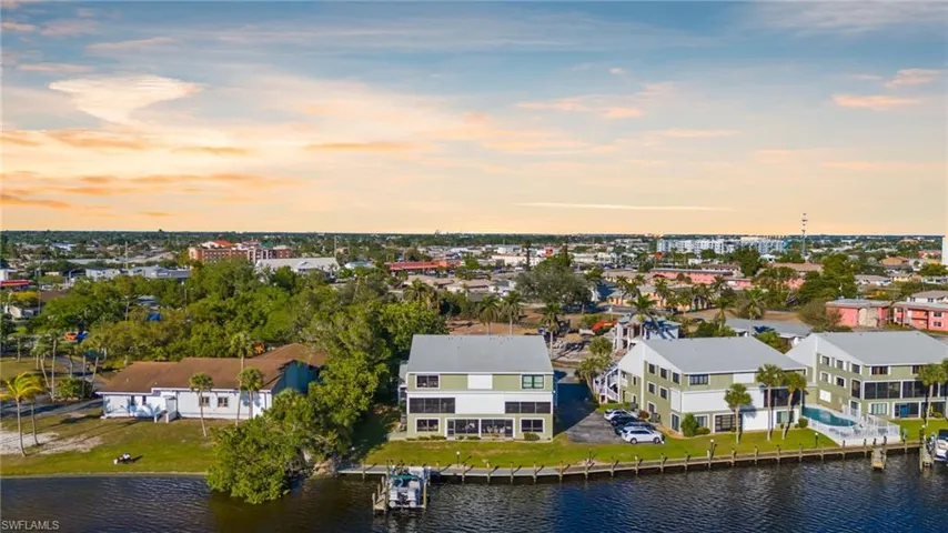 Aerial view at dusk of a water view and a residential view