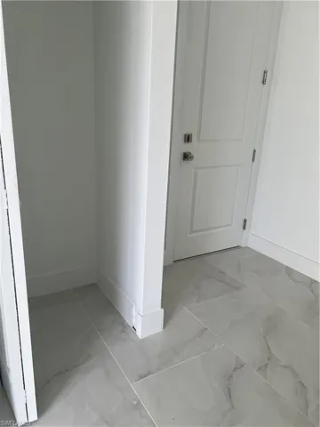 Corridor with light marble finish flooring
