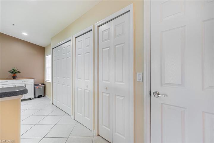 Kitchen with pantry closet, utility closet with hot water heater and laundry