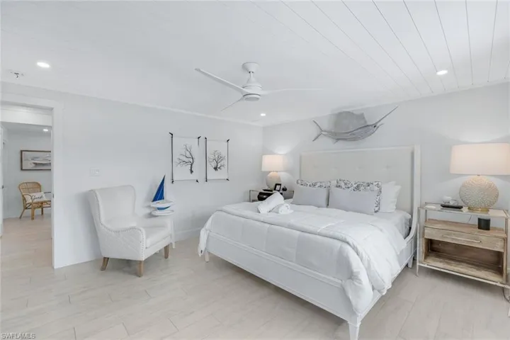 Bedroom with light hardwood / wood-style flooring, ceiling fan, and wooden ceiling