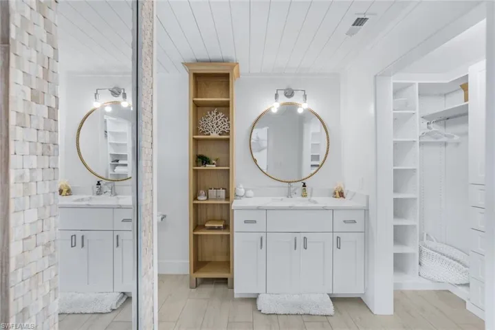 Bathroom with vanity, crown molding, hardwood / wood-style flooring, and wooden ceiling