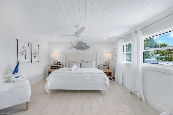 Bedroom featuring light wood-type flooring, ceiling fan, and wooden ceiling