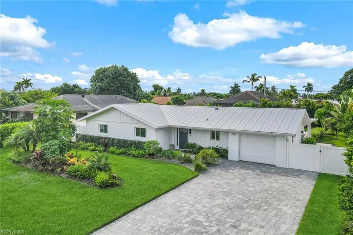 Single story home featuring a front lawn and a garage