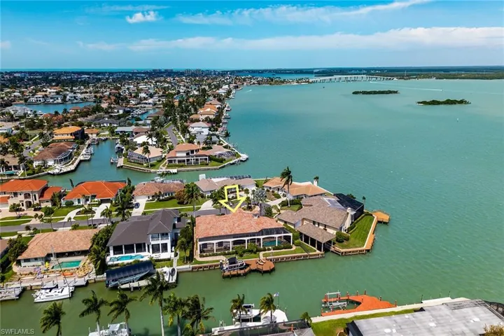 Aerial perspective of suburban area featuring a nearby body of water