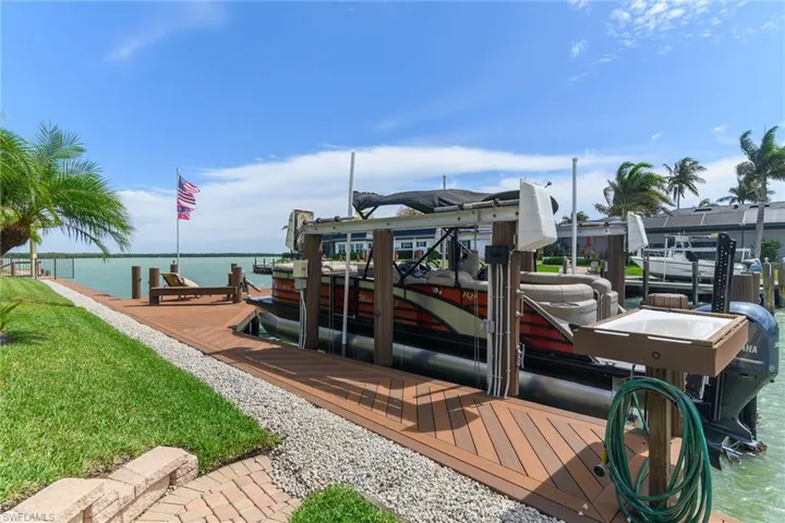 Dock area with a water view and boat lift