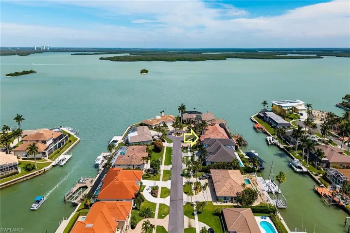 Aerial perspective of suburban area featuring a large body of water