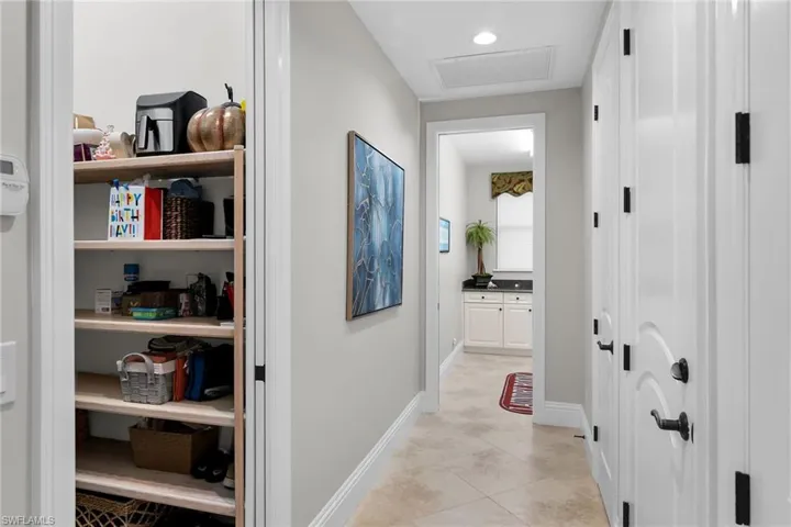 Hallway with attic access and recessed lighting