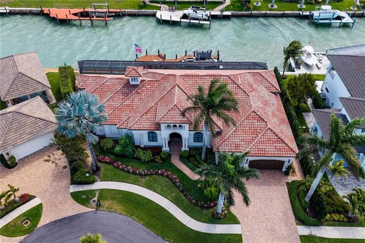 Aerial view of property and surrounding area featuring a nearby body of water