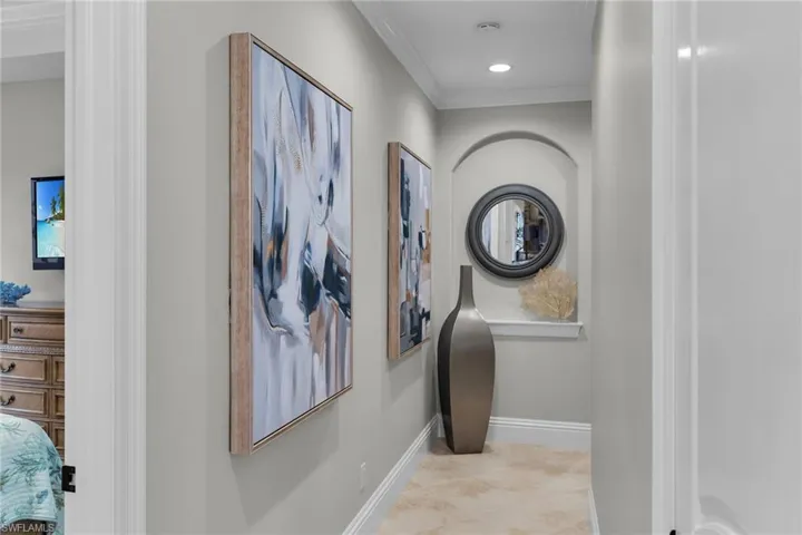 Hallway with crown molding and recessed lighting