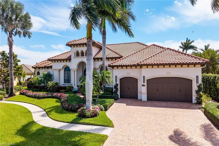 Mediterranean / spanish-style house featuring stucco siding, decorative driveway, a front yard, a garage, and a tile roof