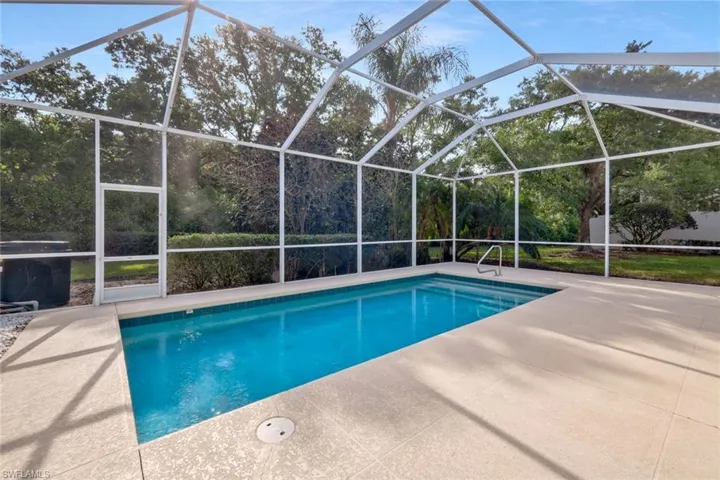 Pool with a lanai and a patio area