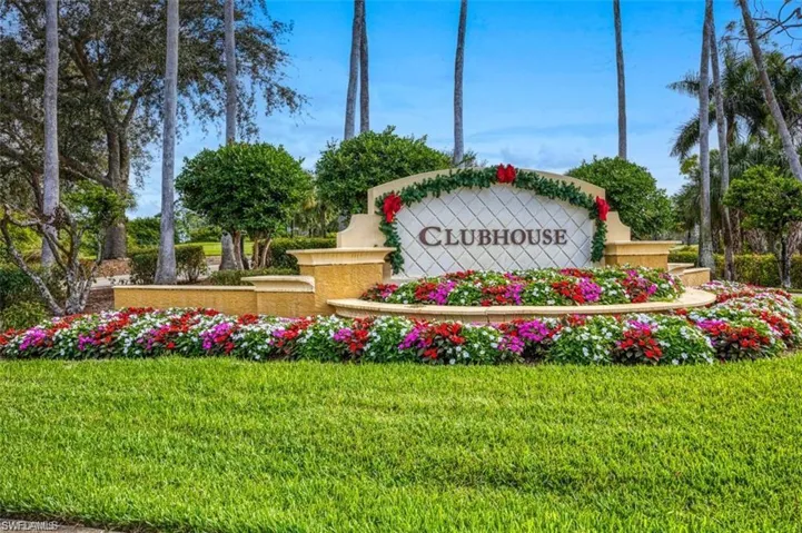 Community / neighborhood sign featuring a yard