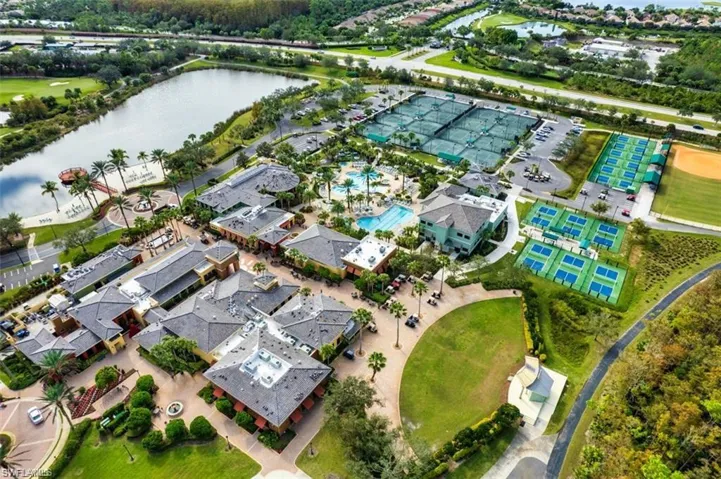 Aerial view of property's location featuring a nearby body of water and nearby suburban area