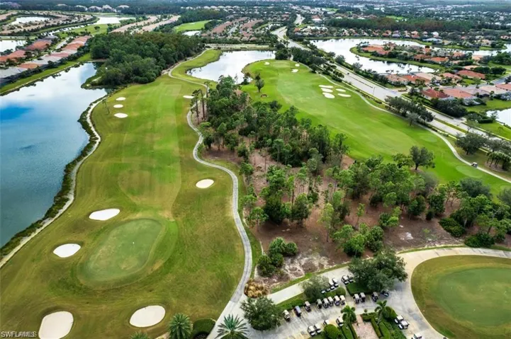 Aerial view of property's location with a large body of water, a golf course, and nearby suburban area
