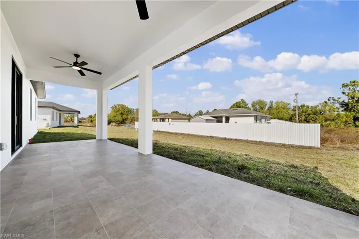 View of patio / terrace with a ceiling fan and a residential view