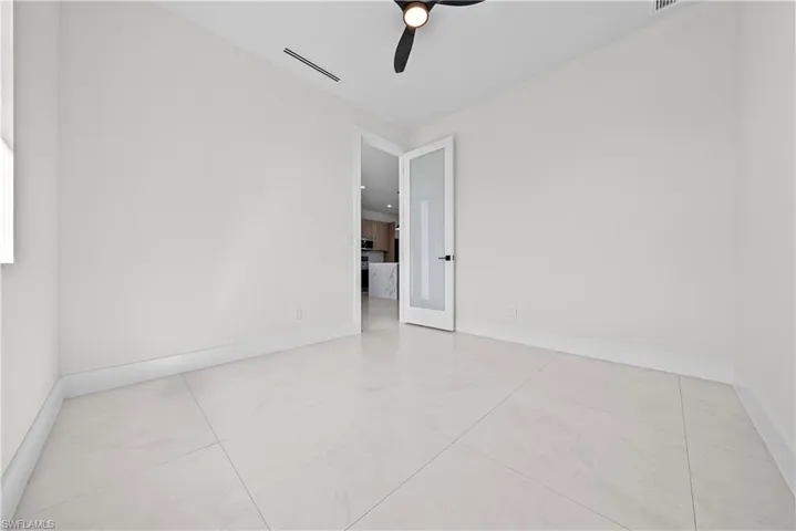 Unfurnished room with baseboards and a ceiling fan